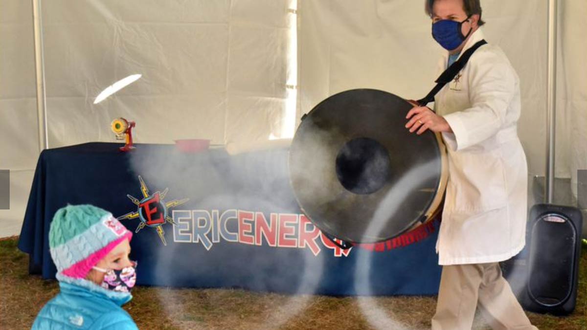 Eric Krupkin, aka Eric Energy, shows Paitin Hankla, 4, of Owings Mills, how a carbon dioxide fog stream freezes into solid balls during "Scientific Magic of Hanukkah," a program held in a tent outside Chizuk Amuno synagogue. Hankla attended the program with her grandmother, Gail Friedler of Pikesville.